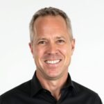 Smiling middle-aged man in black shirt portrait
