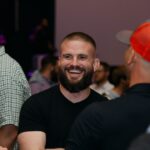 Smiling bearded man at indoor social gathering