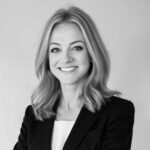 Black-and-white portrait of smiling woman in business attire