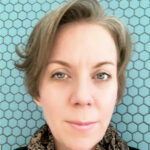 Close-up portrait of woman against blue hexagon tiles