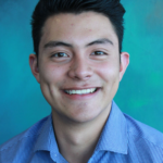 Smiling young man in blue checkered shirt