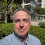 Man taking selfie outside modern office building