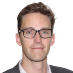 Man wearing glasses against plain background