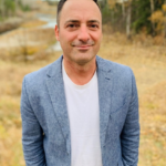 Man in blue blazer outdoors in autumn field