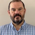 Bearded man in blue plaid shirt portrait