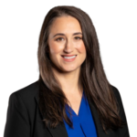 Professional woman smiling in blazer and blue blouse