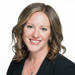 Professional headshot of smiling woman in black blazer