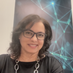 Smiling woman with glasses in modern office setting