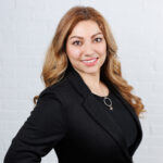 Professional woman smiling in black blazer portrait