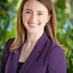 Smiling woman in purple blazer outdoors
